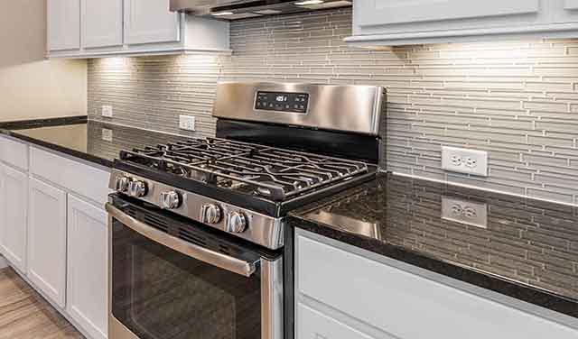 gas range with sleek glass backsplash