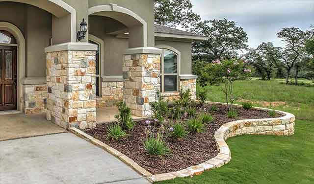 flower bed with mulch and stone border